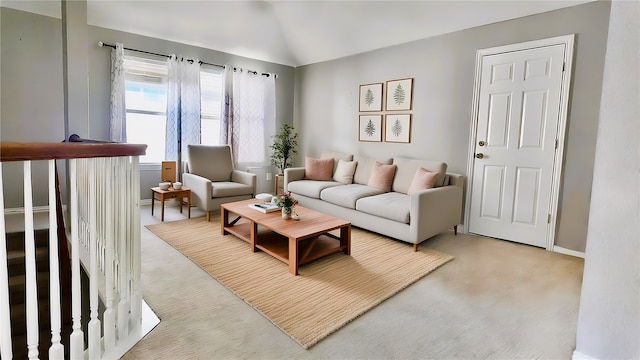 carpeted living room with lofted ceiling