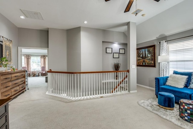 sitting room featuring light colored carpet and ceiling fan