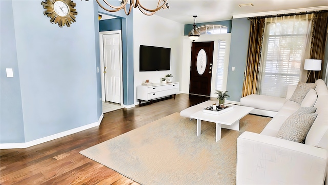 living room featuring hardwood / wood-style flooring and a chandelier