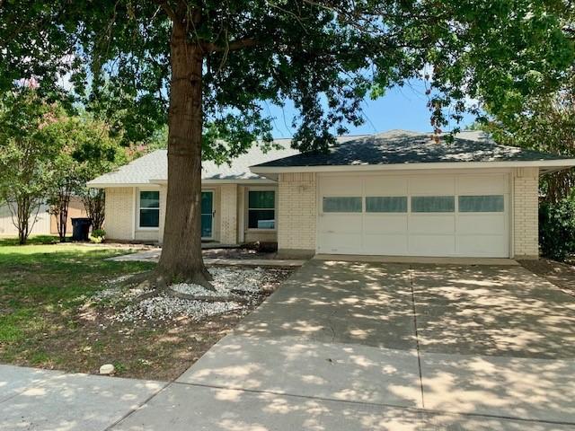 single story home with a garage, concrete driveway, and brick siding