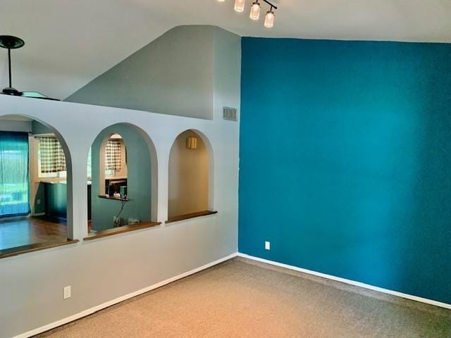 carpeted empty room with lofted ceiling and ceiling fan