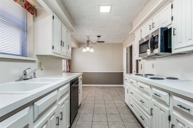 kitchen with hanging light fixtures, black dishwasher, white electric cooktop, sink, and white cabinets