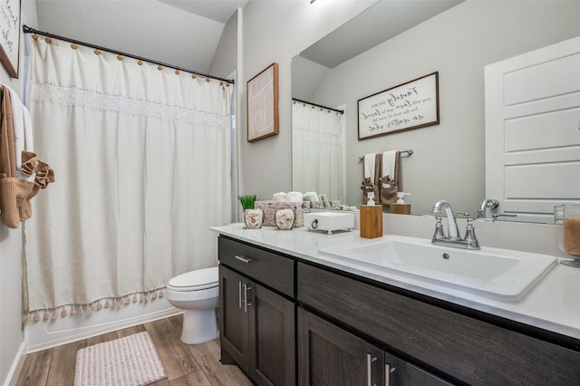 full bathroom with vaulted ceiling, hardwood / wood-style flooring, vanity, toilet, and shower / bath combo with shower curtain