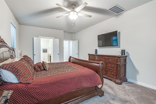 carpeted bedroom with ceiling fan and ensuite bath