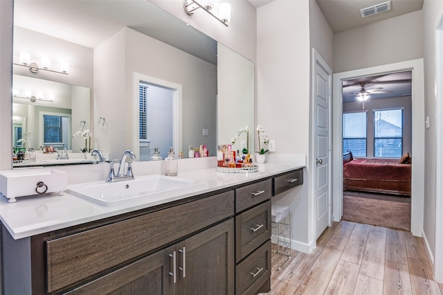 bathroom featuring vanity, hardwood / wood-style floors, and ceiling fan