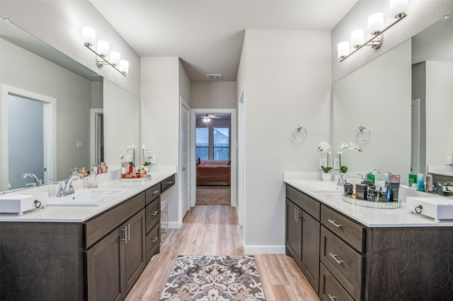 bathroom with vanity, hardwood / wood-style floors, and ceiling fan