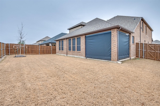 rear view of house featuring a garage