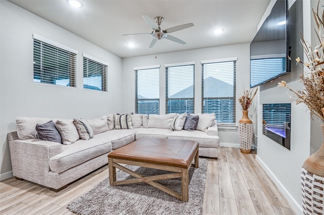 living room featuring ceiling fan and light hardwood / wood-style floors