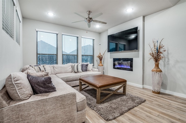 living room featuring ceiling fan and hardwood / wood-style floors