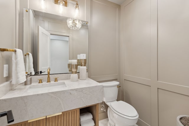 bathroom featuring vanity and toilet