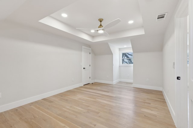 additional living space with ceiling fan and light hardwood / wood-style flooring