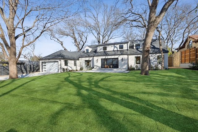 view of front of home featuring a garage and a front yard