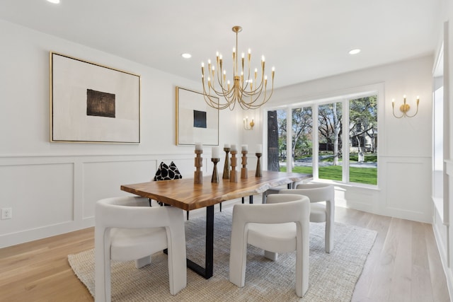 dining room with a notable chandelier and light hardwood / wood-style floors