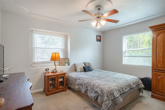 bedroom with ceiling fan and light carpet