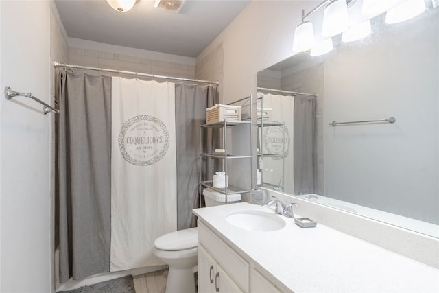 bathroom featuring vanity, a shower with shower curtain, and toilet