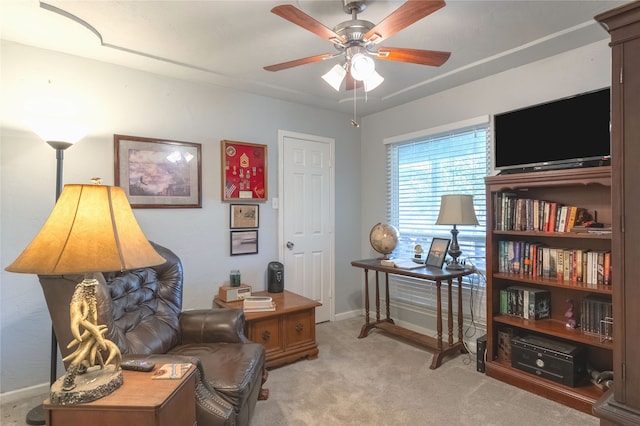 living area with ceiling fan and light carpet