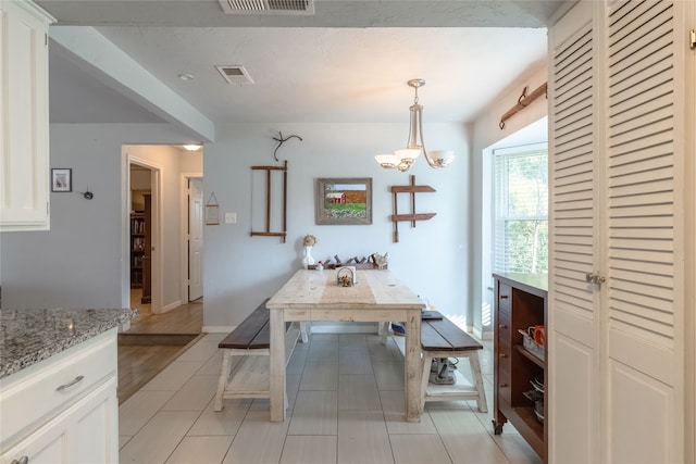 unfurnished dining area featuring an inviting chandelier