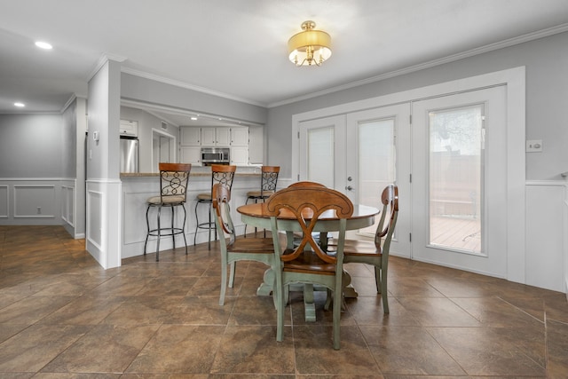 dining room with ornamental molding and french doors