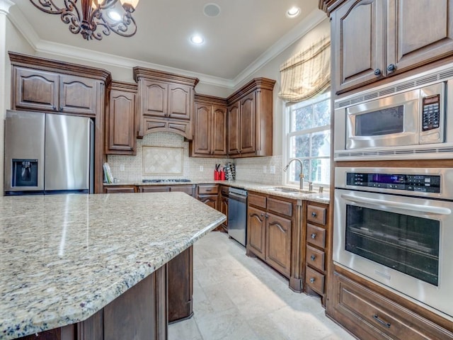 kitchen with tasteful backsplash, crown molding, appliances with stainless steel finishes, and sink