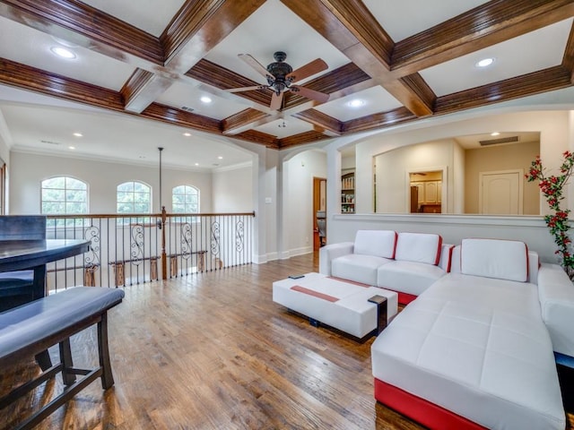 living room with beamed ceiling, wood-type flooring, coffered ceiling, and ornamental molding