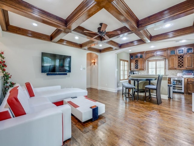 living room with beamed ceiling, coffered ceiling, dark hardwood / wood-style floors, and beverage cooler