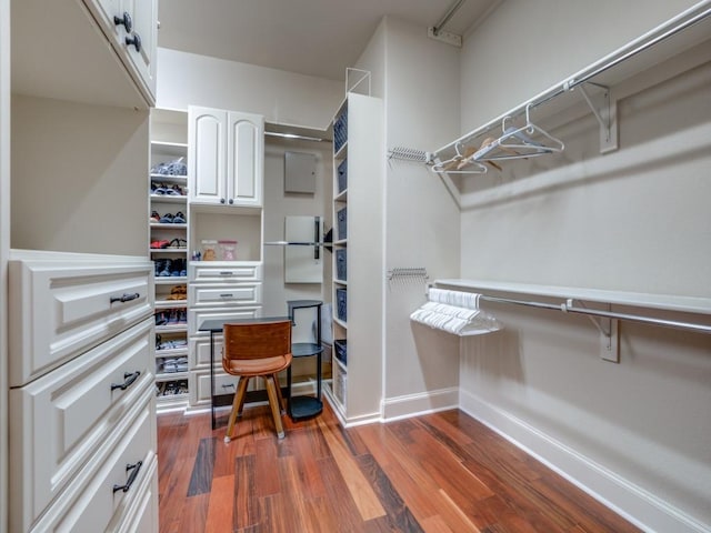 walk in closet with dark hardwood / wood-style flooring