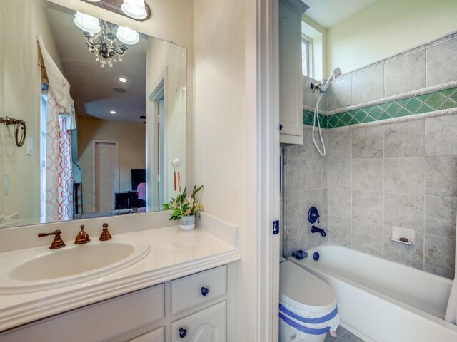 bathroom with a notable chandelier, vanity, and shower / bathtub combination with curtain