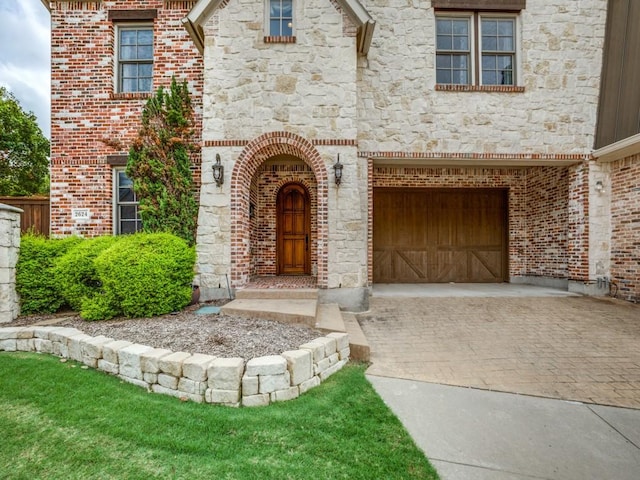 view of exterior entry with a garage