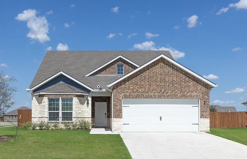 view of front of property featuring a garage and a front yard