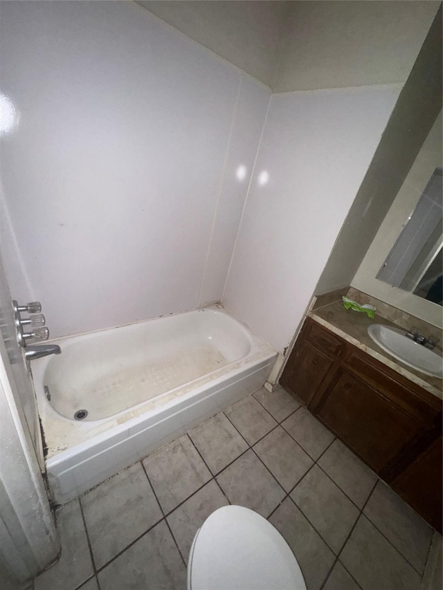 bathroom with tile patterned flooring, vanity, and toilet