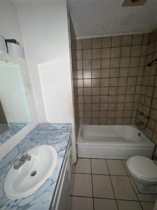 full bathroom with vanity, tile patterned flooring, toilet, and tiled shower / bath combo