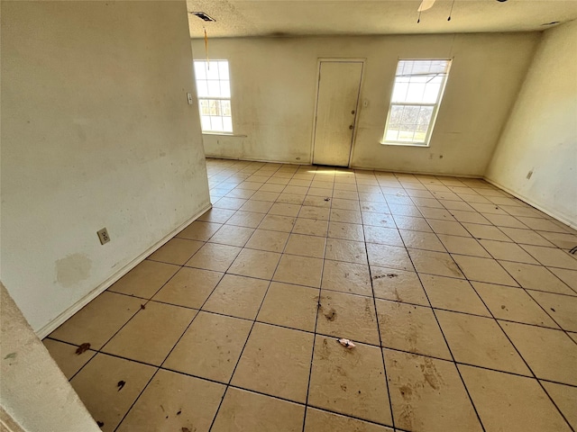 entrance foyer with ceiling fan and light tile patterned flooring