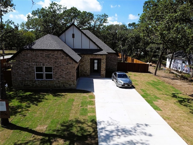 tudor home featuring a front yard