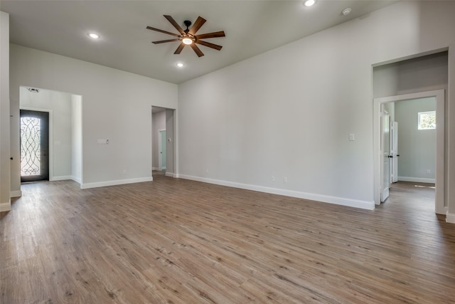 empty room with light hardwood / wood-style floors and ceiling fan