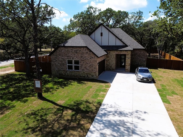 tudor-style house with a front yard