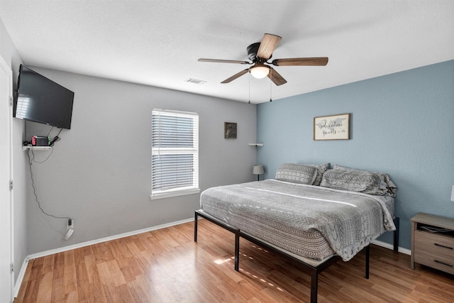 bedroom with hardwood / wood-style flooring and ceiling fan