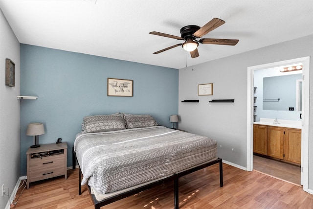 bedroom with ensuite bath, light hardwood / wood-style flooring, and ceiling fan