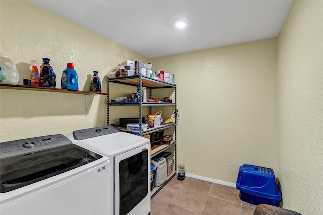 laundry area featuring washer and dryer and light tile patterned floors