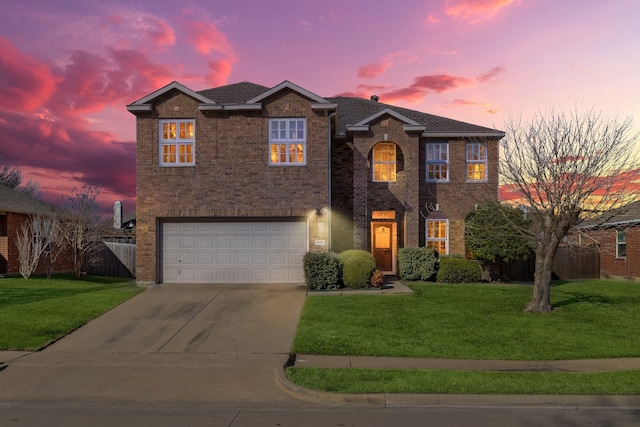 view of front of home featuring a yard and a garage