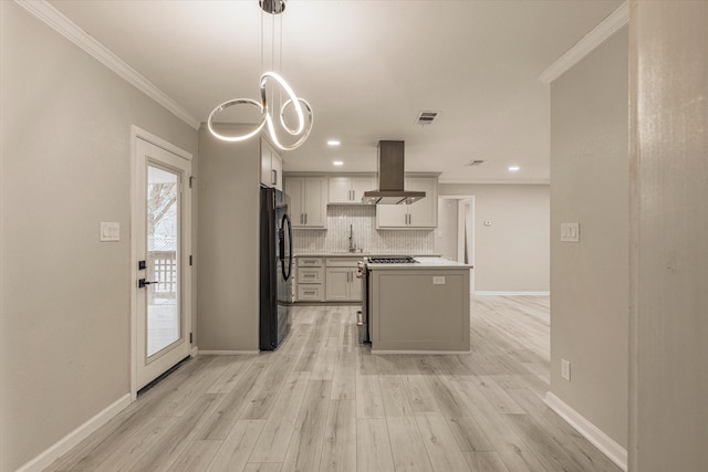 kitchen featuring island range hood, decorative backsplash, hanging light fixtures, ornamental molding, and black fridge with ice dispenser