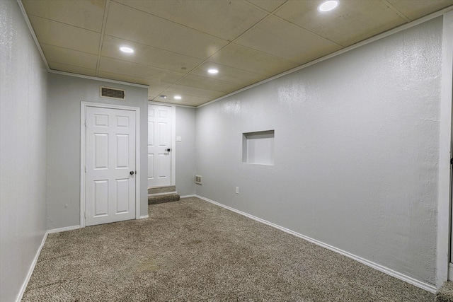 empty room with a paneled ceiling and carpet