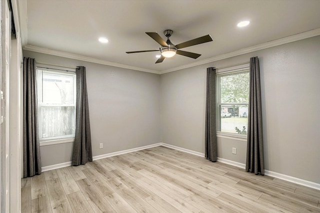 empty room with ornamental molding, light hardwood / wood-style floors, and ceiling fan