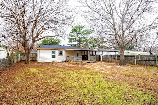 back of property with a lawn