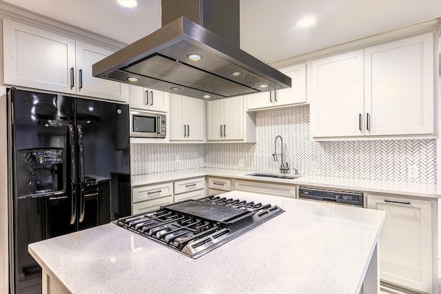 kitchen with island range hood, stainless steel appliances, sink, and white cabinets