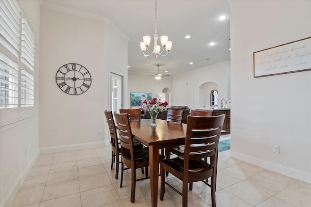 tiled dining space with ornamental molding and ceiling fan with notable chandelier