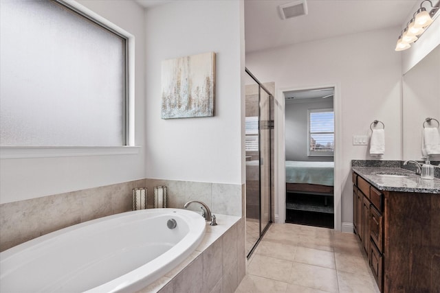 bathroom with tile patterned floors, vanity, and plus walk in shower