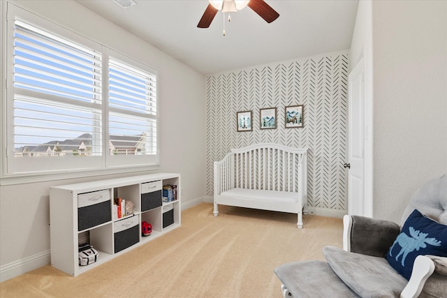 bedroom featuring light colored carpet and ceiling fan