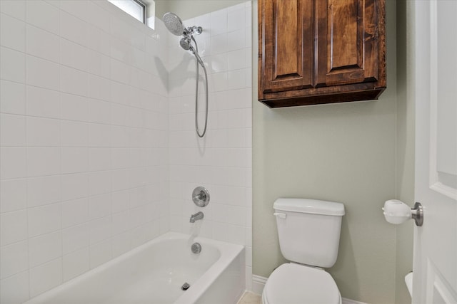 bathroom with toilet and tiled shower / bath combo