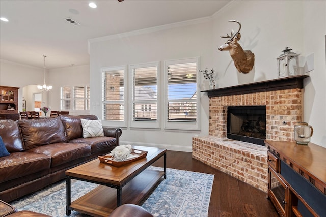 living room featuring crown molding, dark hardwood / wood-style flooring, and a brick fireplace