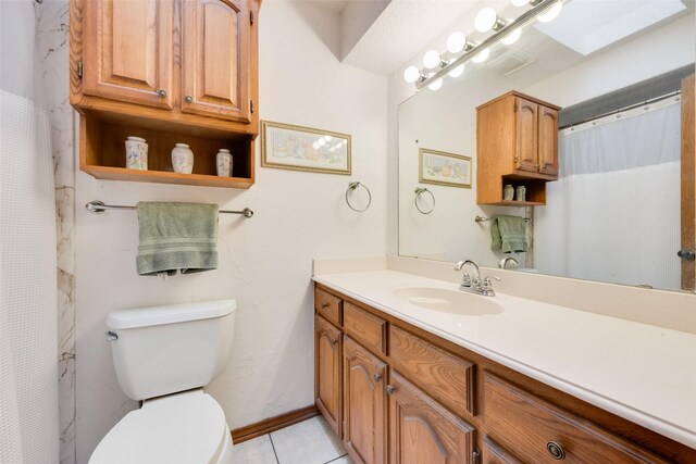 bathroom featuring tile patterned flooring, vanity, and toilet